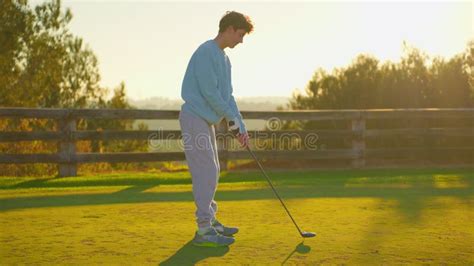 Golf Game A Golfer Hits The Ball In The Sunlight People Sport