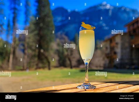 A Champagne Cocktail On An Outdoor Table With A View Of The Famous