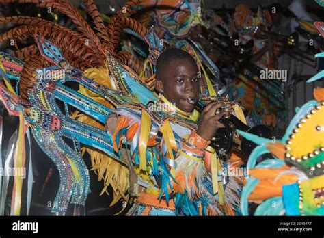 Young Back Man Boy Blowing A Trumpet While Dressed In A Colorful