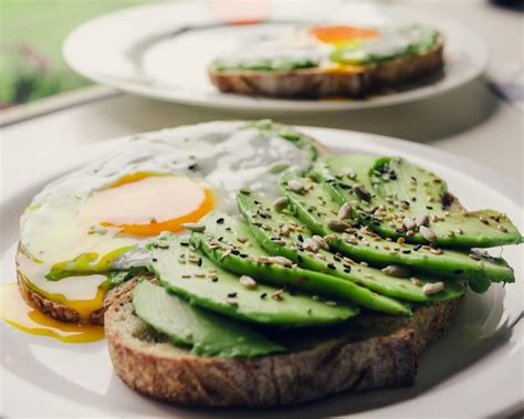 Premium Photo | Healthy breakfast with avocado and delicious wholewheat toast sliced avocado on ...