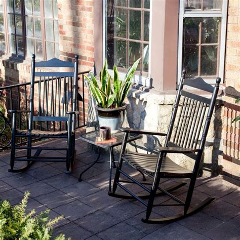 Two Rocking Chairs Sitting On A Porch Next To A Potted Plant