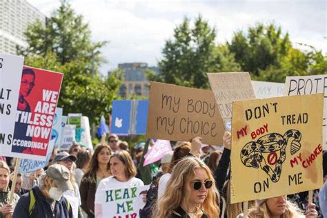 Womens Wave March 2022 Demonstrators Hold Signs During The Womens March