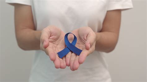 March Colorectal Cancer Awareness Month Woman Holding Dark Blue Ribbon