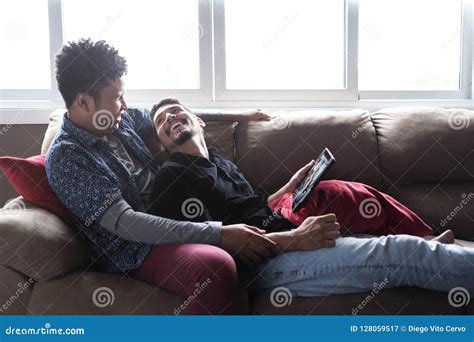 Happy Gay Couple Looking At Pictures On Tablet Stock Image Image Of