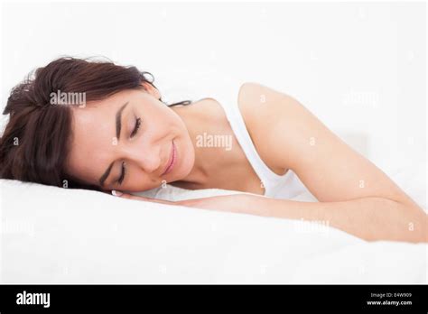 Brunette Woman Falling Asleep In Her Bed Stock Photo Alamy