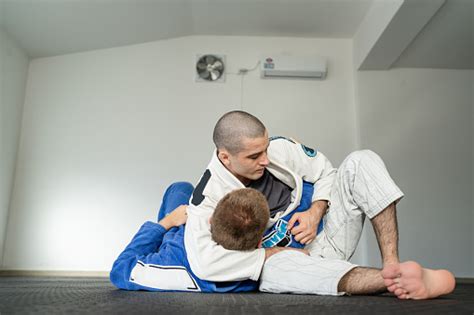 Two Athletes Training Brazilian Jiu Jitsu Kesa Gatame Side Control Hold