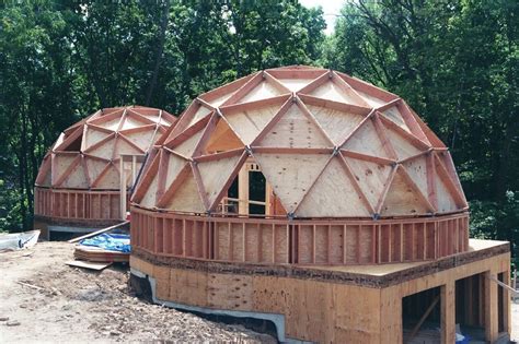 Two Large Domes Sitting On Top Of A Wooden Platform In The Middle Of A