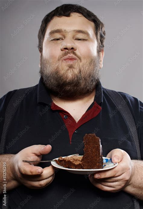 funny fat guy eating chocolate cake Stock Photo | Adobe Stock