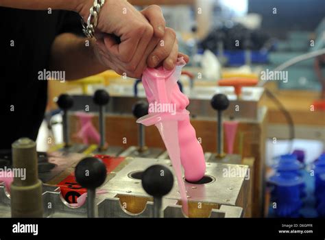 An Employees Pulls A Silicon Dildo Out Of The Mold At The Fun Factory In Bremen Germany