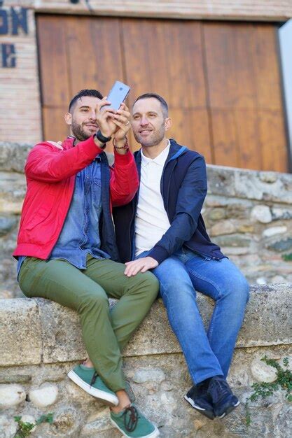 Premium Photo Gay Couple Embracing While Doing Selfie Outdoors