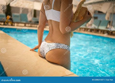 Elegant Woman In White Bikini In The Sun Tanned Slim And Slender Body