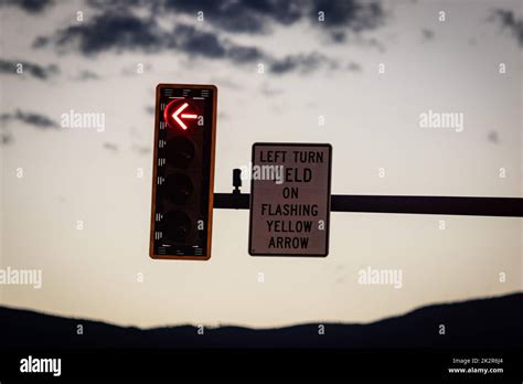 A Closeup Shot Of A Traffic Light And Sign Indicating Left Turn Yield