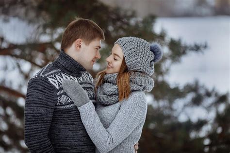 The Couple Hugs and Smiles while Standing in the Snow. Stock Photo - Image of happy, love: 262776480