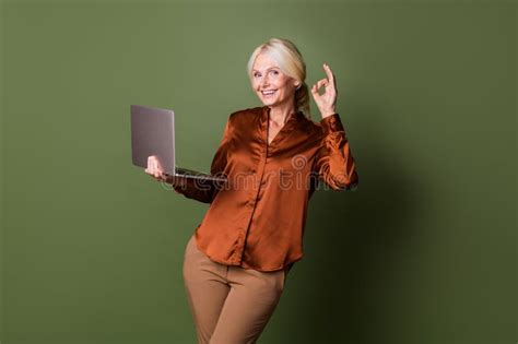 Photo Portrait Of Lovely Senior Lady Hold Netbook Show Okey Symbol Wear