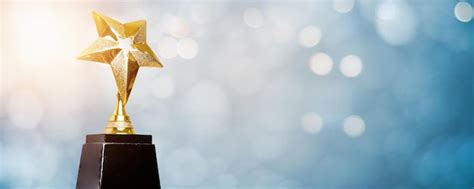 Premium Photo | Golden trophy award bokeh soft blue background, Winner or 1st place gold trophy ...