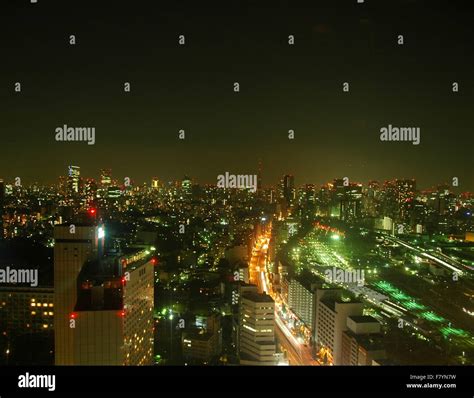 Tokyo lights at night, Tokyo, Japan. On the right are rail yards of the ...