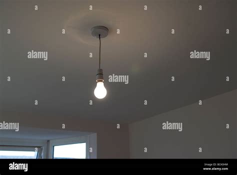 Bare light bulb without a shade room and window Stock Photo - Alamy