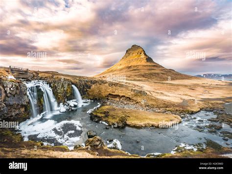 Mount Kirkjufell with Kirkjufellsfoss Waterfall, cloudy atmosphere ...