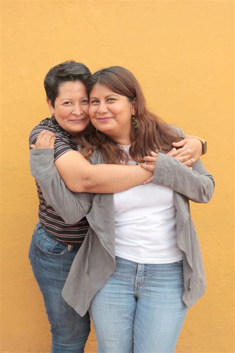 Married Latina Couple Cuddling Standing On The Beach Stock Photo