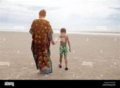 Mother And Son Walking On The Beach Stock Photo Alamy