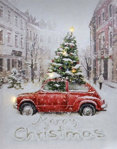 A Red Car Parked In Front Of A Christmas Tree