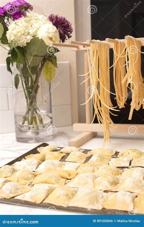 Homemade Spaghetti Drying On A Pasta Rack And Ravioli Ready To B Stock