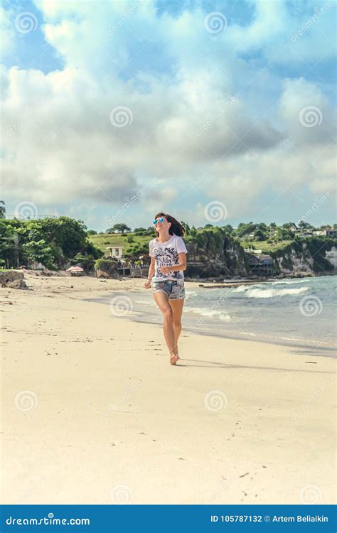 Beautiful Young Woman In Sunglasses Posing On The Beach Of A Tropical