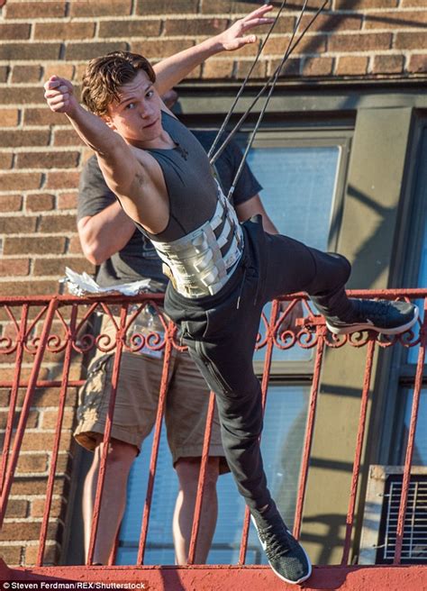 Tom Holland Dangles Off A Balcony While Performing Stunts For Spider