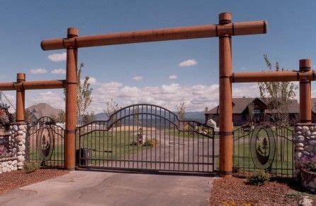 Entry With Gate, Fence, Logs And Stone Columns.. would love to have this in front of my ranch ...