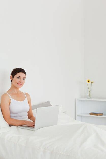 Premium Photo Portrait Of A Beautiful Brunette Using A Laptop
