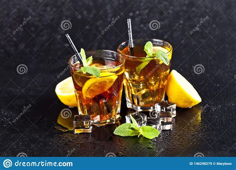 Two Glasses With Cold Traditional Iced Tea With Lemon Mint Leaves And