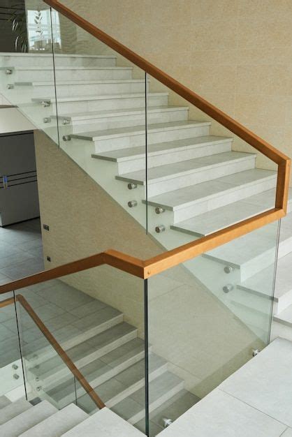 Modern Staircase With Glass Railing And Wooden Handrail