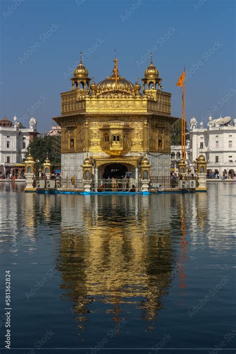 Darbar Sahib Golden Temple Amritsar with its reflection sarovar Nishan ...