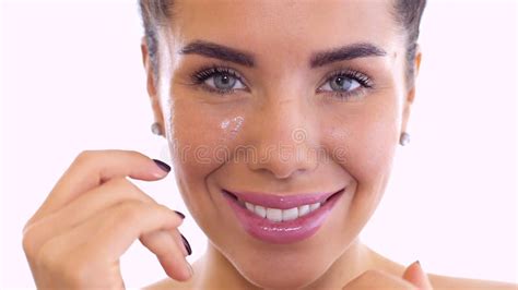 Beautiful Woman Rubs Cream In Face At White Background Stock Footage