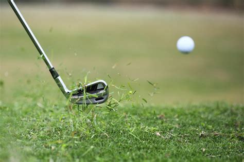 Golf Club Hits Ball In The Air With Grass Flying Mccormick Woods Golf Club