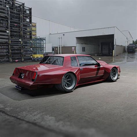 A Red Sports Car Parked In Front Of A Warehouse