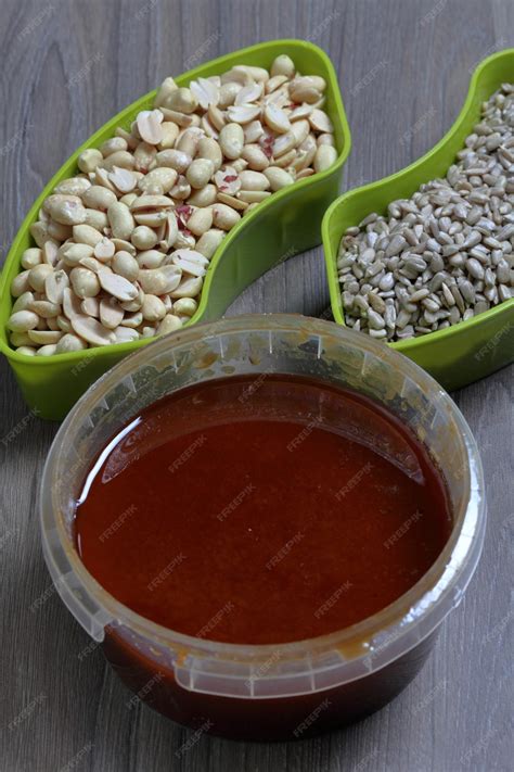 Premium Photo | Honey in a container Next to separate containers of