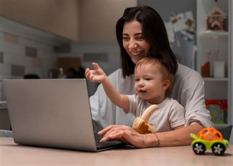 Free Photo Medium Shot Mother Working And Holding Baby