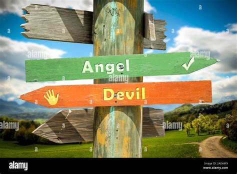 Street Sign To Angel Versus Devil Stock Photo Alamy