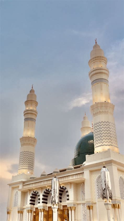 Two Tall White Buildings Sitting Next To Each Other