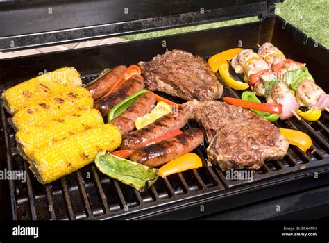 A Barbecue Spread Of Corn On The Cob Bratwurst Steak Sirloin Fillets