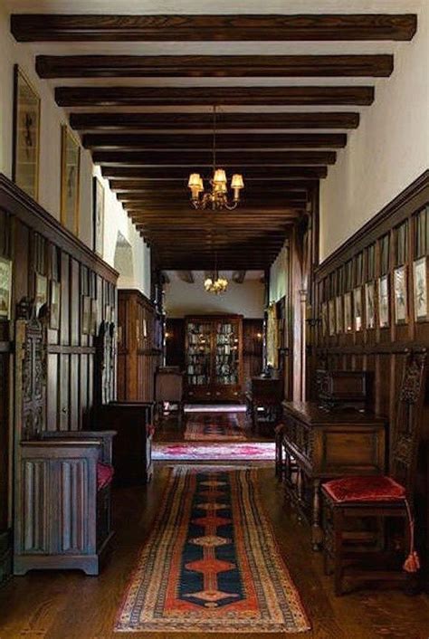 A Long Hallway With Wood Paneling And Wooden Furniture On Either Side