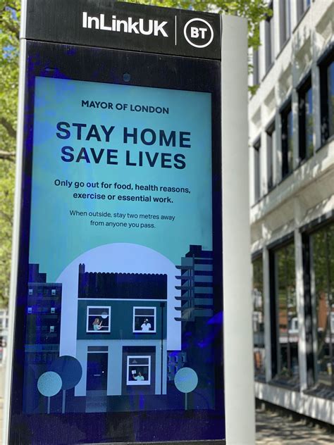 A sign in front of a building that says stay home save lives photo