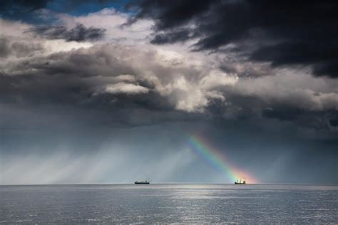 A Rainbow Through Storm Clouds Over An Photograph by John Short - Pixels