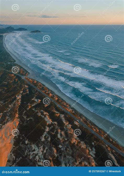 Aerial Shot Of The Beach With Foamy Waves During The Sunset Stock Image