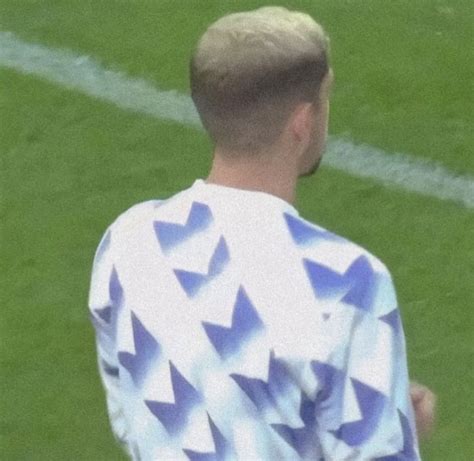 A Man Standing On Top Of A Soccer Field