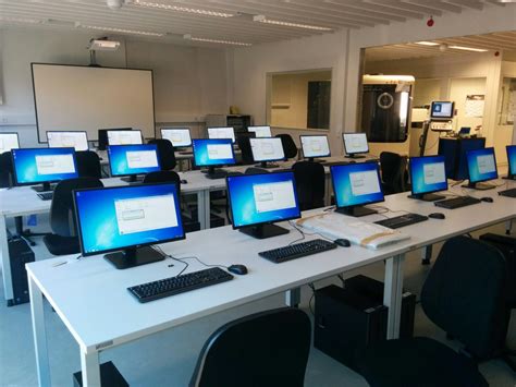 There Are Many Computers That Are On The Desk In This Office Building