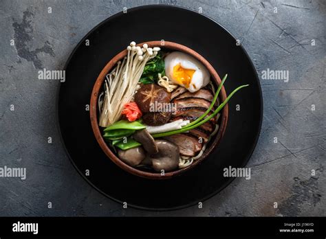 Ramen Noodles With Duck Egg Enoki And Shiitake Mushrooms With Broth