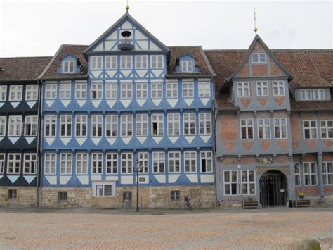 An Old Building With Blue And White Paint On It S Side In Front Of A