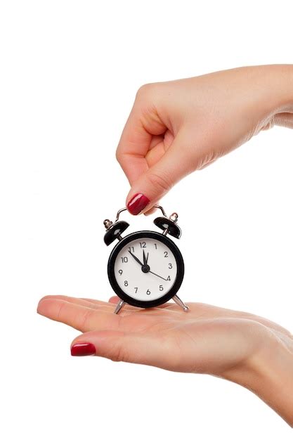 Premium Photo Female Hand Holding Alarm Clock